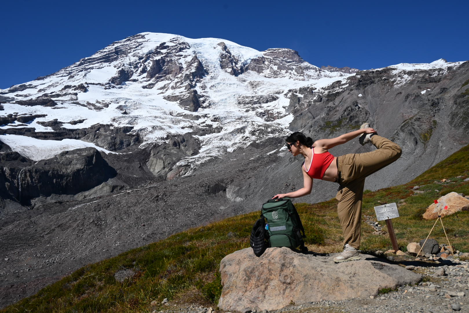Athlete stretching beside the MON Supply prototype in the mountains